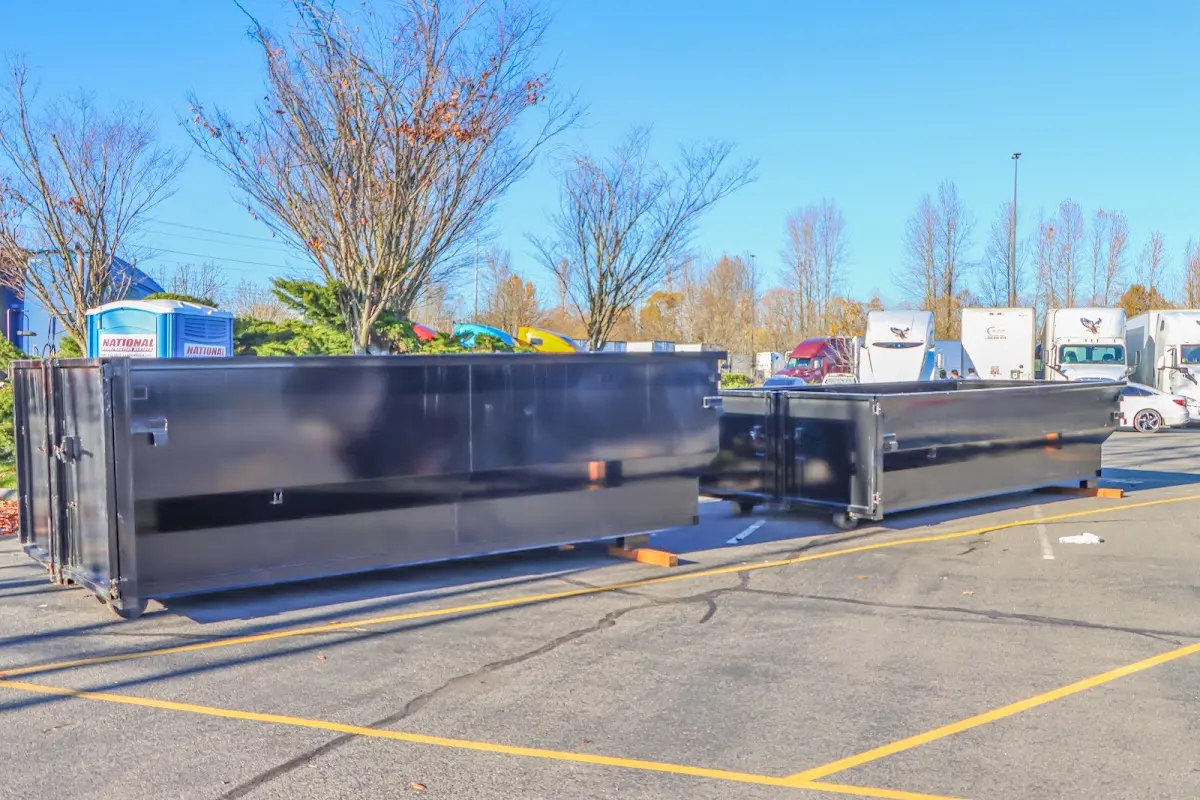 Professional dumpster rental service with roll-off container on residential driveway in Midway City
